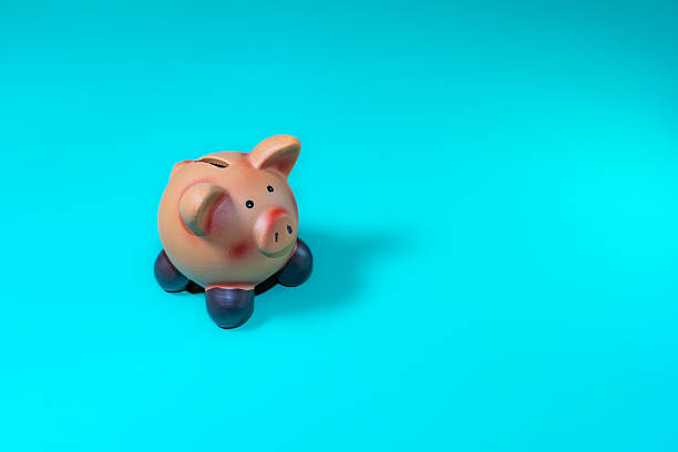 istock Piggy Bank on Bright Blue Background 2239576324