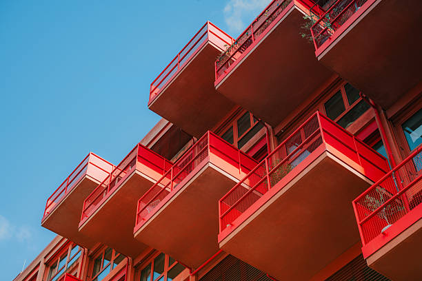 red balconies of modern residential architecture  in Berlin against blue sky