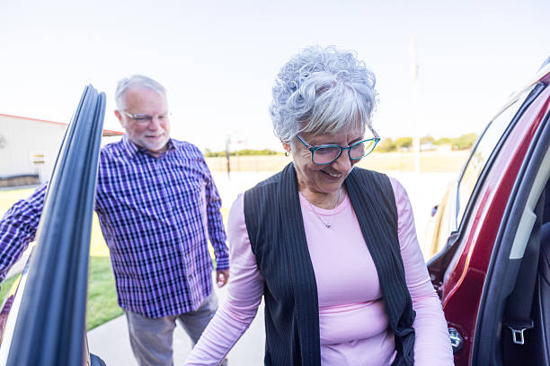 istock Senior couple preparing and embarking on a weekend getaway loading the car 2239579678