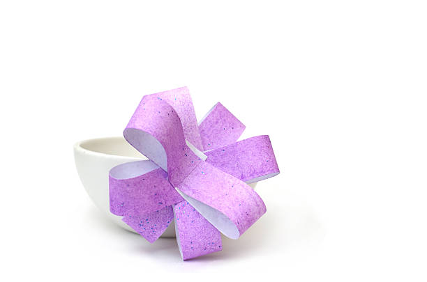 Kraft paper small gift box with red bow on white background with copy space.