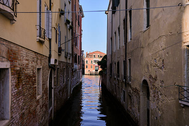 Peaceful waterway surrounded by aged walls in Venice Italy