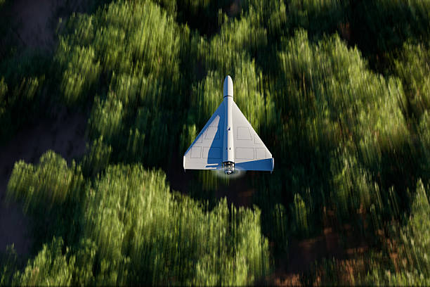 Top shot of a military UAV or drone (shahed-136) flying over forest area with the ground blurred