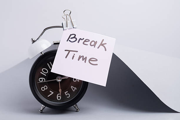 istock Break time. Coffee and clock on a colored background.  Time to drink coffee.  Creative idea. 2239583625