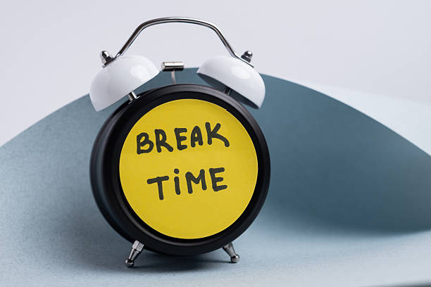 istock Break time. Coffee and clock on a colored background.  Time to drink coffee.  Creative idea. 2239583695