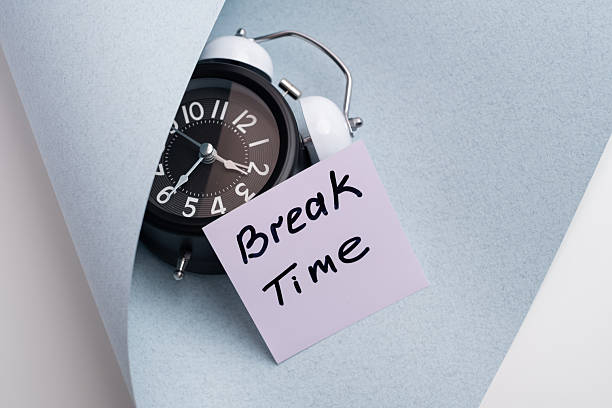 istock Break time. Coffee and clock on a colored background.  Time to drink coffee.  Creative idea. 2239583703