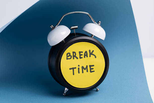 istock Break time. Coffee and clock on a colored background.  Time to drink coffee.  Creative idea. 2239583739