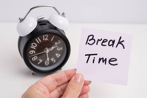 istock Break time. Coffee and clock on a colored background.  Time to drink coffee.  Creative idea. 2239584219