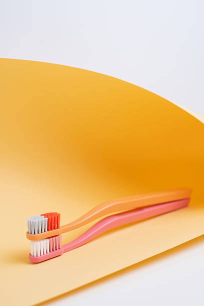 istock Colored toothbrushes on a color background. Replace your old toothbrush with a new one. Old and new toothbrushes. Dental health and hygiene concept 2239584619