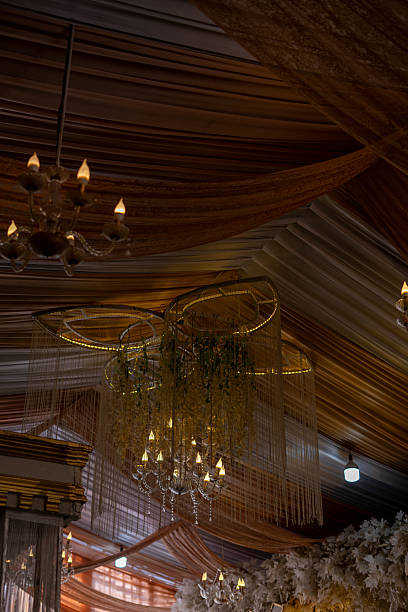 istock Elegant Chandeliers and Draped Fabric Ceiling Adorned for Festive Event 2239585394