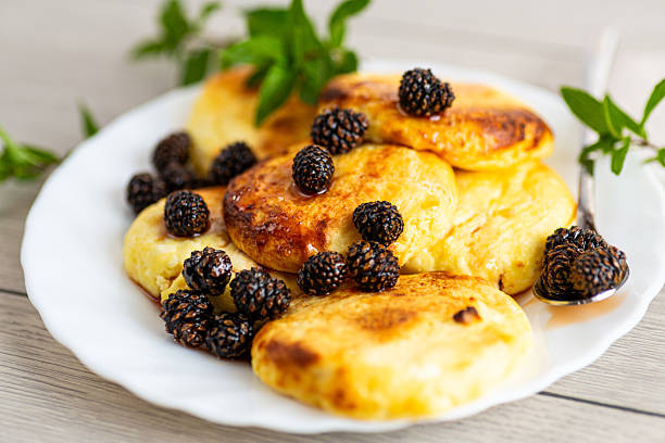 Cottage cheese pancakes with pine cone jam and mint.