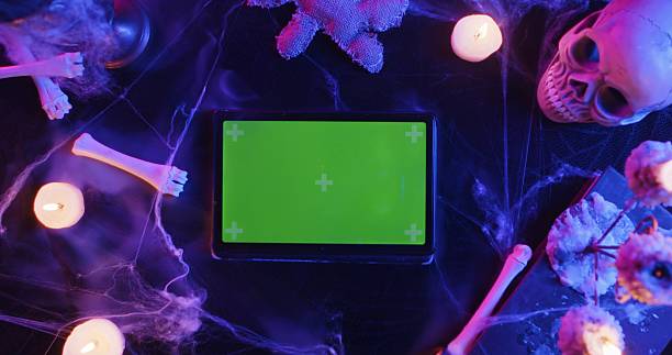 Halloween Scene with Skull, Bones, Candles, and Tablet