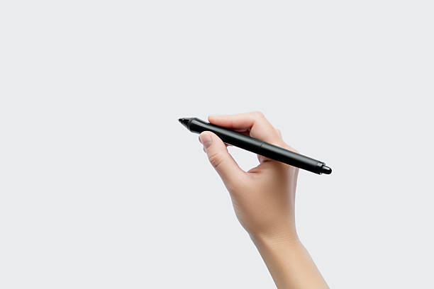 istock Hand holding a black stylus pen ready to write 2239590228
