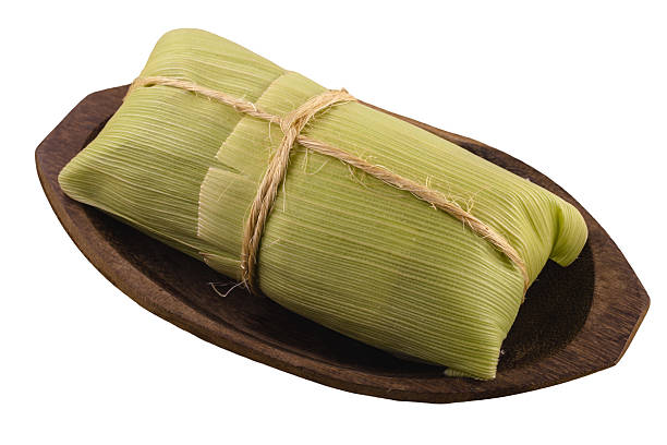istock pamonha, brazilian corn sweet, packaged with straw, served in these juninas, on isolated white background 2239591978