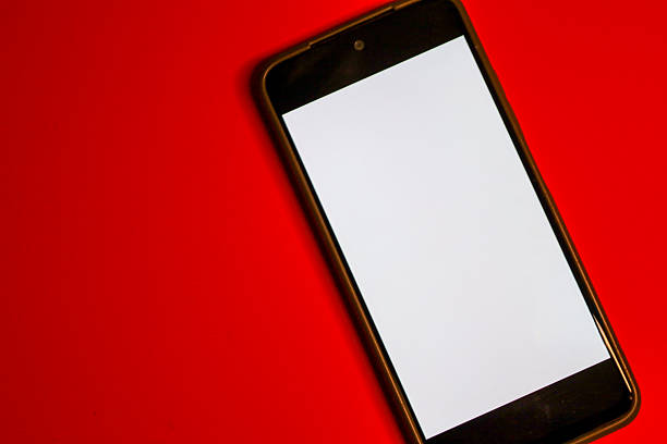 istock A smartphone with a clean white screen is positioned diagonally on a saturated red background, creating a strong, passionate color contrast. 2239592194