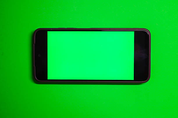 istock A smartphone with a green screen in horizontal orientation rests on a saturated green background, creating a monochromatic look. 2239592216