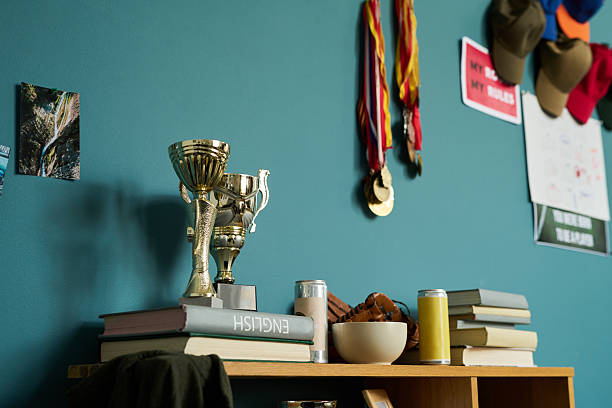 istock Stack of Books and Trophies Displaying Academic and Athletic Achievements 2239592465