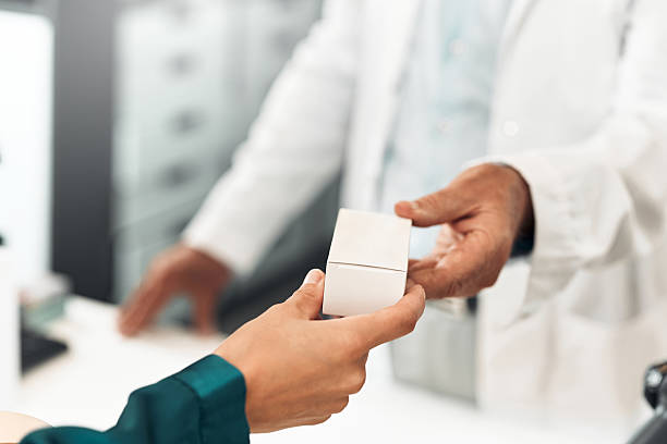 istock Customer receiving product from pharmacist at checkout counter 2239597405