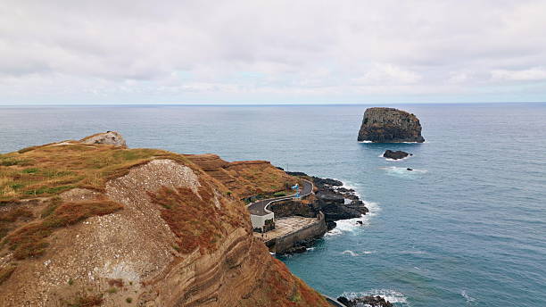 istock Rocky shore extending sea water drone view. Mountain slopes washed by blue ocean 2239600535