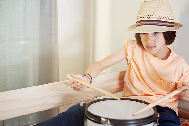 istock Boy focused on playing snare drum in natural light 2239606499