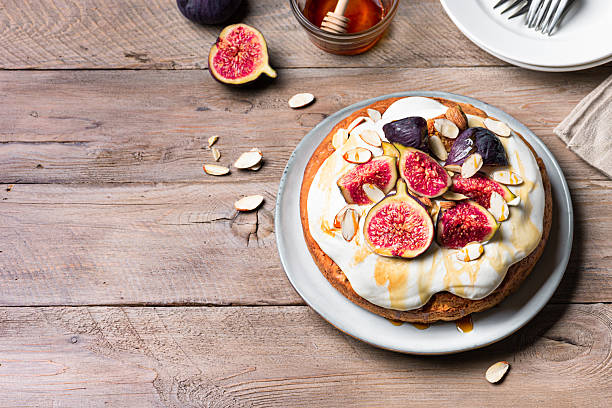 istock Honey sponge cake with whipped cream, figs and almond 2239606795