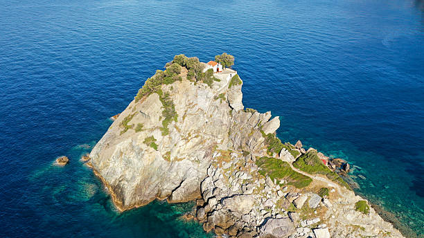 istock A remote white chapel on a rocky headland above the sea. 2239606878