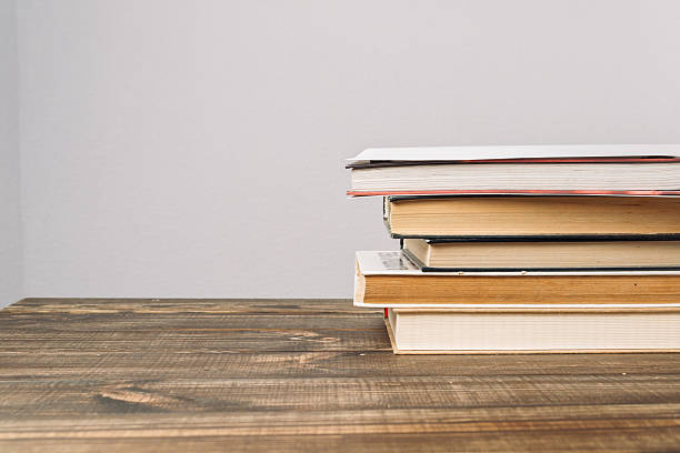 istock Stack of books on wooden table, symbolizing learning and knowledge in an educational environment 2239607980