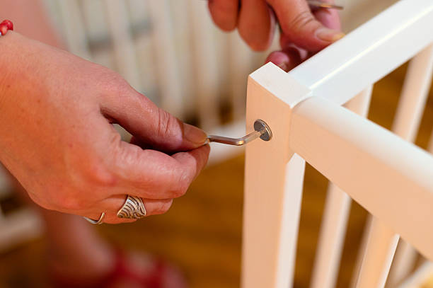 istock Woman assembling wooden baby cradle 2239608727