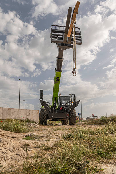 istock Forklift on a construction site, preparing to raise construction parts 2239609254