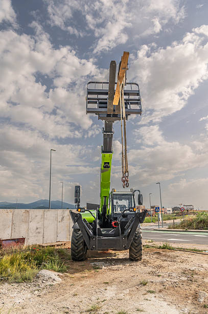 istock Forklift on a construction site, preparing to raise construction parts 2239609269