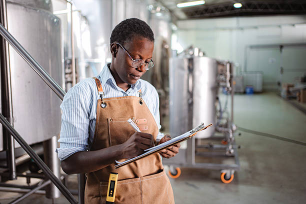 istock Woman working in brewery doing quality control inspection 2239613026