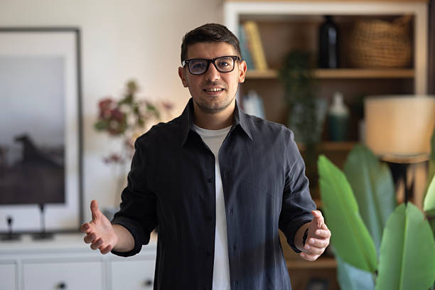 istock Pov entrepreneur talking camera interview in office. Online coach waving hand 2239617361