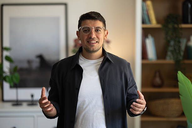 istock Pov entrepreneur talking camera interview in office. Online coach waving hand 2239618015