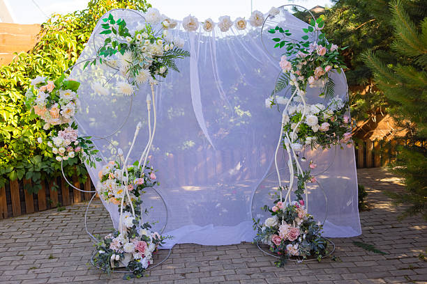 istock Wedding arch decorated with cloth and flowers outdoors. Beautiful wedding set up. 2239624681