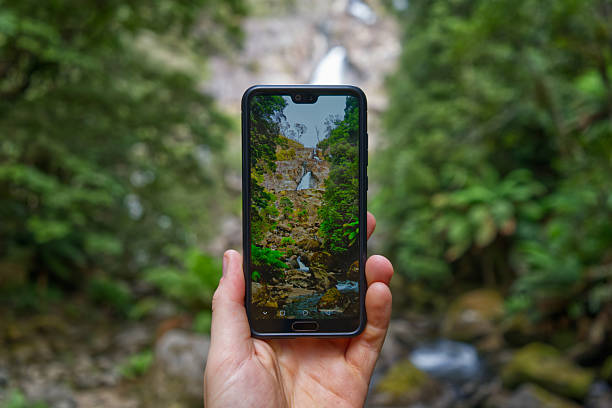 istock Photography through phone of waterfall 2239625335