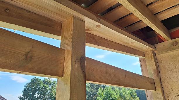 istock Wooden beam framework under construction with outdoor view 2239626344
