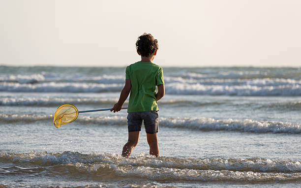 Young local boy attempting to catch fish at the pier in Sal, Cape Verde