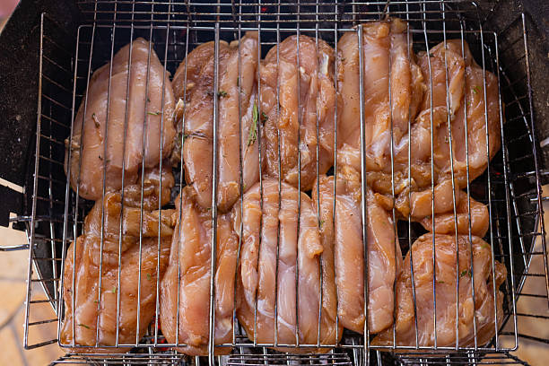 Marinated grilled chicken on the flaming grill