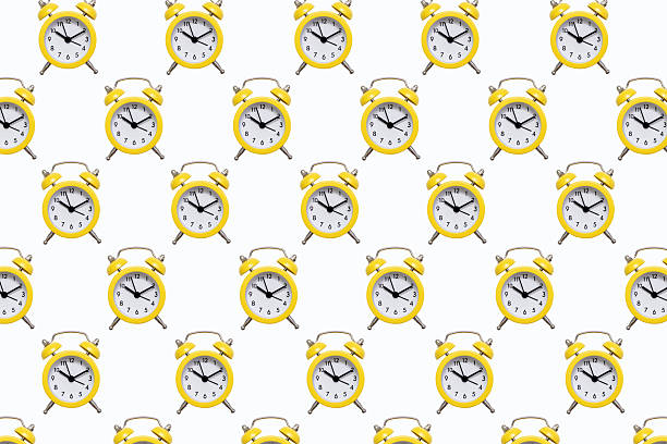 istock Pattern from yellow alarm clocks on a white isolated background 2239633578
