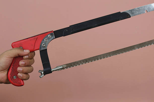istock Asian Male hand holding hacksaw 2239637209