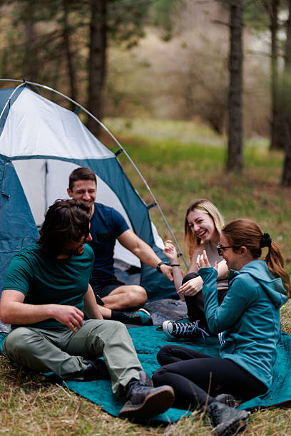 istock Friends enjoy a relaxing camping trip surrounded by nature in a forest setting during a sunny afternoon 2239648414