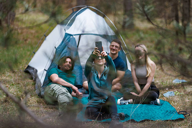 istock Friends enjoying a camping trip in the woods, taking selfies and sharing laughter during a relaxing day in nature 2239648421