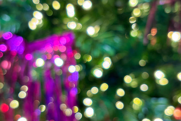 Abstract Christmas holiday with festive gold bokeh light on Christmas tree blurred background