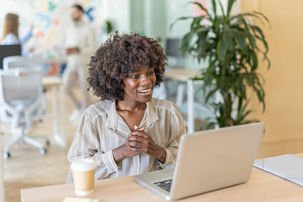 istock Enthusiastic woman smiles while typing at her laptop 2239652729