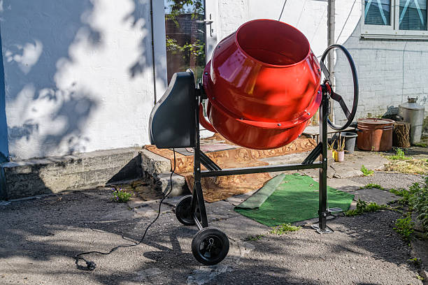 Red concrete mixer. Construction equipment. Construction site