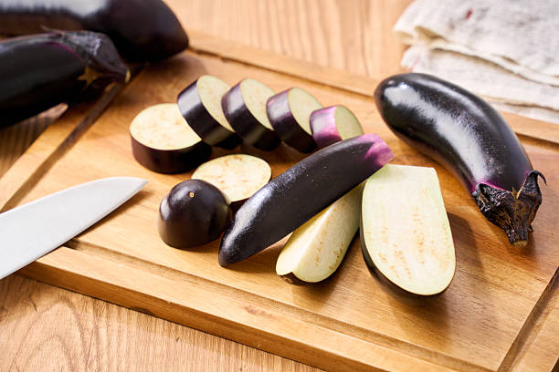 istock Sliced Eggplant on Wooden Cutting Board for Cooking 2239661598