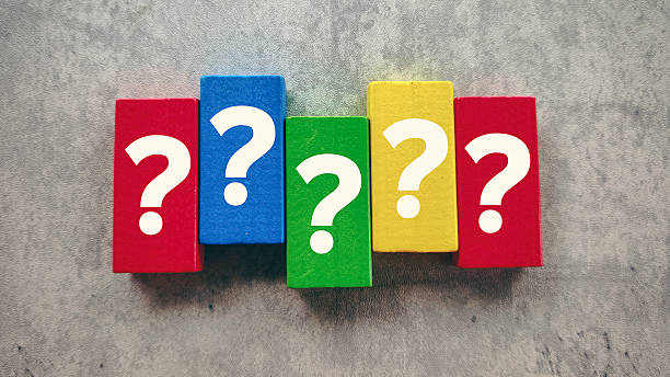 istock Vibrant Question Marks on Colorful Wooden Blocks on a Grey Background Representing Problem Solving and Doubt 2239661666