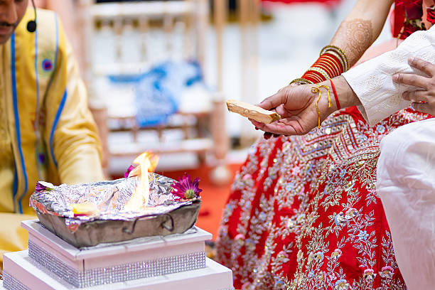 istock Indian traditional wedding ceremony ritual items and hands close up 2239664090