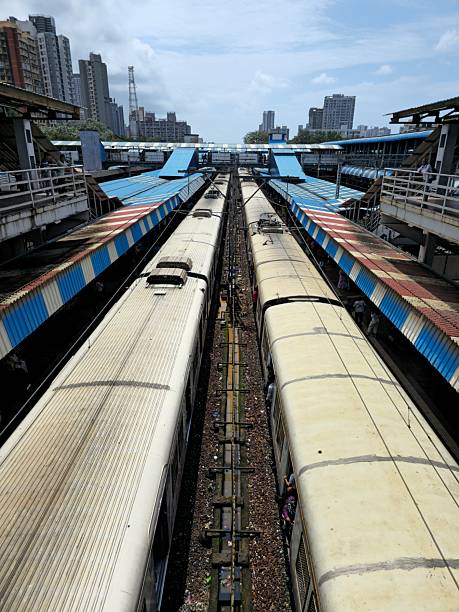 Local train passing though station elevated view located in rural India. The shot is taking from the bridge.