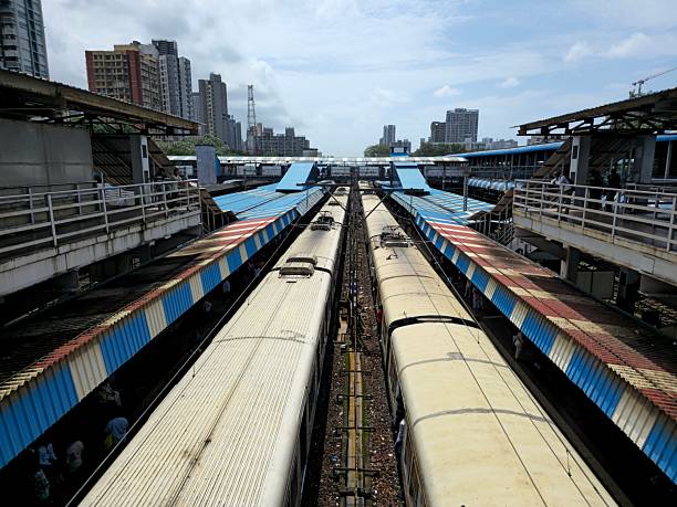 Local train passing though station elevated view located in rural India. The shot is taking from the bridge.
