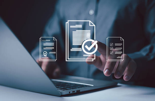 istock Businessman using laptop with digital document and check mark icons, symbolizing online approval, electronic certification, and data verification in modern digital business workflow. 2239665970